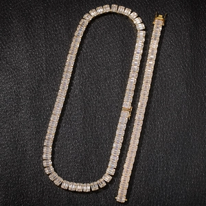 Detail view of gold hip hop jewelry set with baguette cut cubic zirconia stones