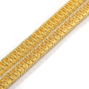Macro detail of polished gold square frame chain links with a mirror finish