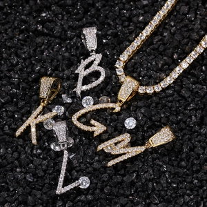 Hip hop style gold and silver cursive letters with zircon stones on black stones