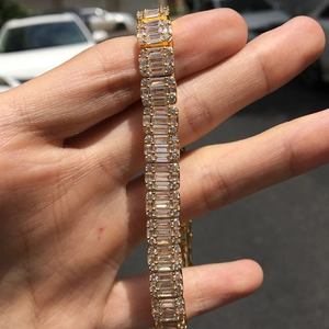 Detail of hip hop gold bracelet featuring emerald-cut zircons and pave set micro stones
