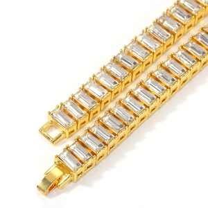 Detail of gold tennis chain with baguette-cut zircons and secure folding clasp