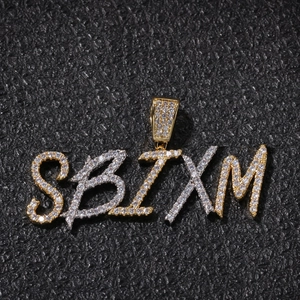 Macro view of iced out custom hip-hop letter pendants with sparkling zircon stones