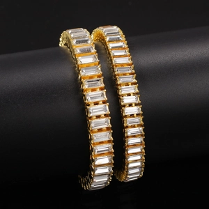 Hip hop style gold tone bracelet set featuring rectangle cut white crystals on display stand