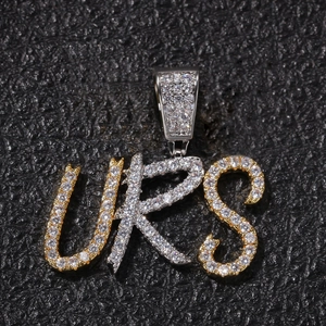 Detail of custom URS iced out pendant with gold and silver plating and zircons