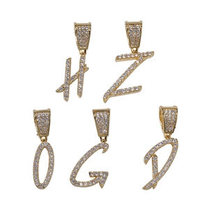 Macro detail of custom hip hop pendants H, Z, O, G, D with gold plating and zircon inlay