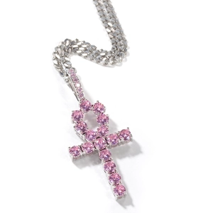 Detailed close-up of hip hop Ankh cross pendant with pink zircons on silver Cuban chain