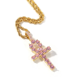 Close-up of gold twist chain with pink zircon pavé-set Ankh cross pendant