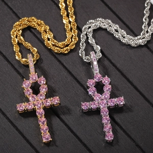 Detail of hip hop Ankh key pendants with pink zircon stones on gold and silver rope chains