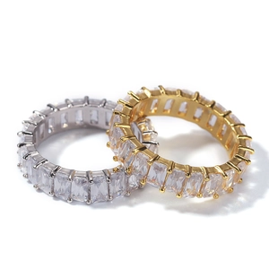 Detail of gold and silver hip hop eternity rings featuring baguette-cut cubic zirconia
