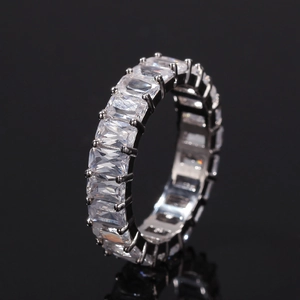 Macro shot of a silver hiphop ring with emerald-cut cubic zirconia in an eternity band style