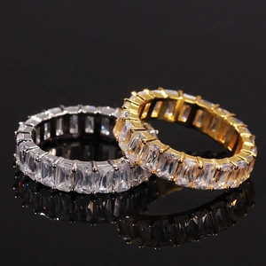 Macro shot of silver and gold hip-hop eternity rings with rectangular zircon stones
