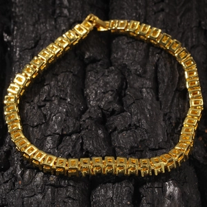 Close-up of 4mm golden hip hop tennis bracelet with square links on black wood