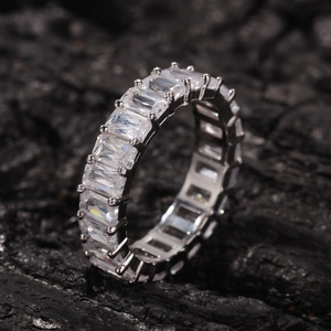 Macro view of men's hip hop ring featuring baguette-cut cubic zirconia in a silver band