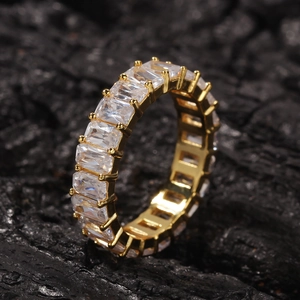 Detailed macro shot of hiphop eternity ring with baguette-cut zircons in gold finish