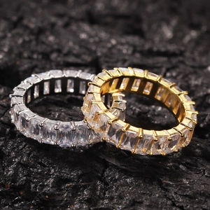 Close-up of gold and silver hip hop eternity rings with square-cut cubic zirconia