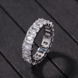 Detailed macro view of an eternity ring with emerald cut cubic zirconia in prong setting