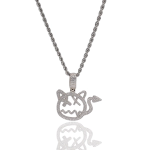 Detailed macro of a hip hop cartoon devil pendant with micro-pave zircons and rope chain