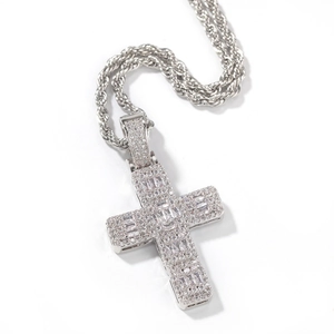 Détail du pendentif croix hip hop argenté avec zircons taille baguette sur chaîne corde