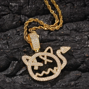 Detail of hip hop devil pendant in gold finish with sparkling cubic zirconia inlay