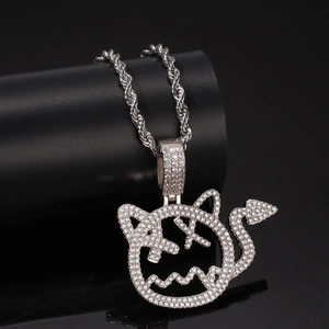 Macro shot of hip-hop demon pendant with iced-out cubic zirconia on a silver twist chain