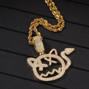 Close-up of hip hop devil pendant with gold plating and sparkling zircon stones