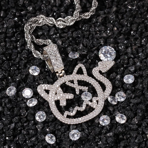 Detail of silver devil pendant necklace with zircon stones on a black stone background