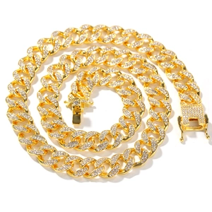 Close-up of 13mm gold Cuban link chain with pave-set cubic zirconia and secure box clasp