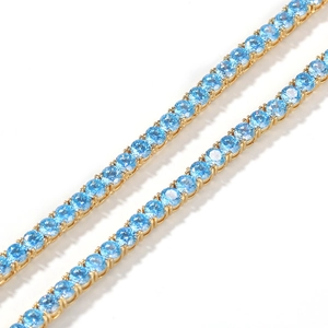 Detail of 4mm tennis chain with gold plating and light blue zircon gemstones