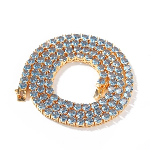 Close-up of 4mm gold tennis chain with blue zircon stones in a circular layout
