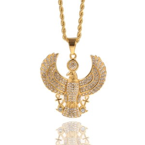 Hip hop style gold eagle pendant with white rhinestones and twisted chain on white background