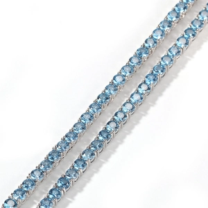 Detailed macro view of 4mm sea blue zirconia tennis chain necklaces in silver finish