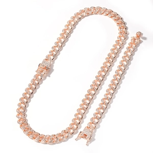 Macro detail of rose gold Cuban link set featuring hand-set crystals and secure buckle