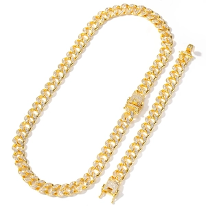 Detail showing gold Cuban link chain set with sparkling rhinestones and square clasp