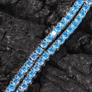 Macro shot of 4mm ice blue cubic zirconia tennis necklace with silver prong setting