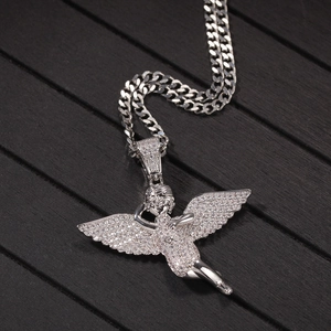 Macro shot of hip hop angel wing pendant with pavé cubic zirconia on cuban chain