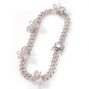 Detail of silver Cuban link necklace with micro-paved zircon butterfly charms
