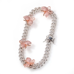 Close-up of Cuban link necklace with micro-paved pink butterfly pendants and silver plating