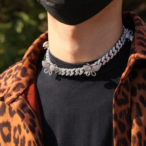Close-up of hip hop butterfly Cuban link necklace with micro-pave zircons on male model