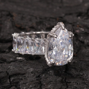 Macro shot of luxury teardrop pear-cut zircon ring on charcoal background