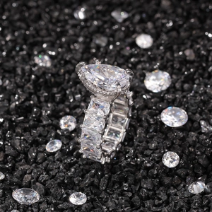 Macro shot of silver pear-cut teardrop ring with pavé rectangular cubic zirconia stones