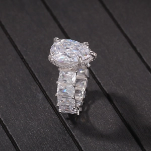 Macro shot of silver pear-cut teardrop ring with rectangular baguette zircon stones