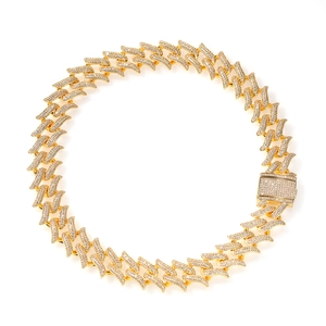 Close-up of golden hip hop chain with lightning bolt links and cubic zirconia stones