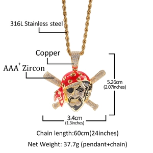 Detailed view of gold plated pirate skull pendant with zirconia and red enamel details