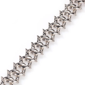 Macro detail of silver hip hop thorn Cuban chain showing polished metal texture and punk style