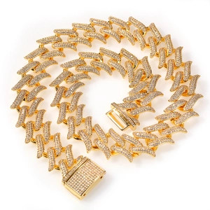 Detail of 20mm golden hip hop Cuban chain with pave zircons and thorn pattern clasp