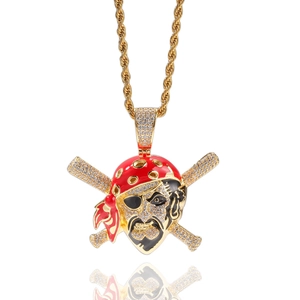 Detail of hip hop skull pendant with micro-paved zircons on twisted gold chain