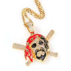 Macro detail of gold plated pirate skull pendant with red enamel and micro zircon stones