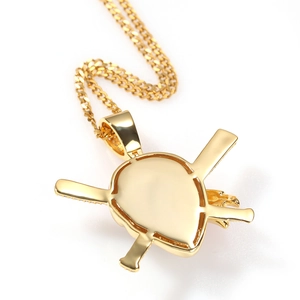 Detailed back view of a golden pirate skull pendant showing smooth polished metal finish