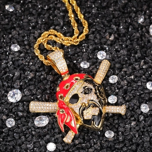 Detailed close-up of pirate skull pendant with red bandana on gold hip hop rope chain