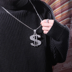 Close-up of hip-hop silver dollar sign pendant necklace and iced out ring with white zircons